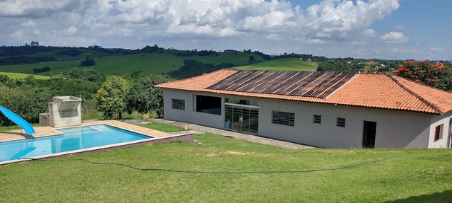Huge farm with pool, game room and lots of green.